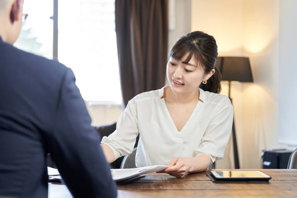 istock Asian female business woman explaining 1308090288