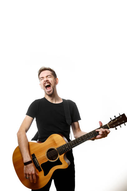 istock Guitarist playing and singing loudly on isolated a white background. 1308091755