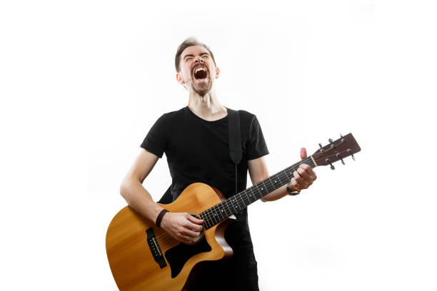 istock Guitarist playing and singing loudly on isolated a white background. 1308091759