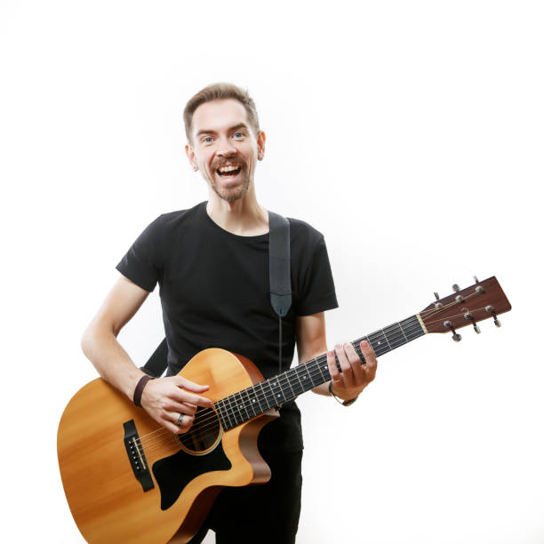 istock man playing on the guitar on the white background. 1308091761