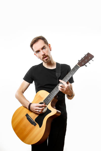 istock man playing on the guitar on the white background. 1308091765