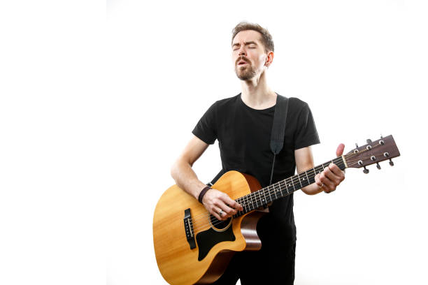 istock The young man plays the guitar. Isolated white background 1308091798