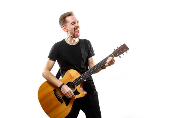 istock The young man plays the guitar. Isolated white background 1308091820