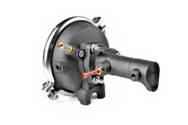 vacuum brake booster of car pneumatic system. auto brake system detail, white background close-up selective focus