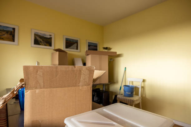 istock Active senior man alone in empty apartment room while moving house unpacking from cardboard boxes 1308095399