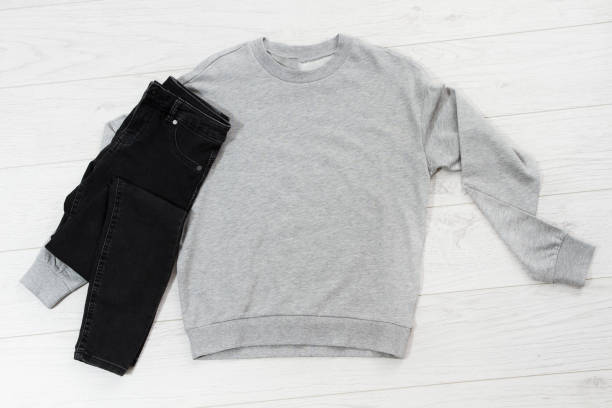 istock Close up gray blank template sweatshirt hoodie with copy space. Top view mockup pullover on white wooden background. Casual outfit. Flat lay template clothes. 1308095996