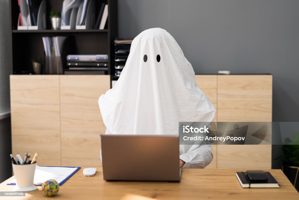 Ghostwriter In Office. Creative Ghost Writer Ghostwriter In Office. Creative Ghost Writer Using Computer Humor Stock Photo