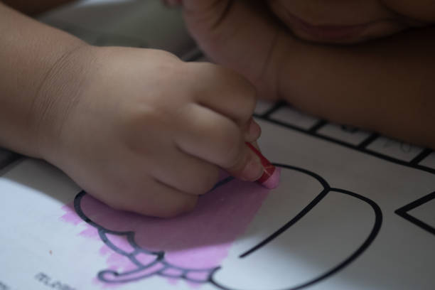 istock Little boy having fun to paint on paper. Selective focus 1308098669