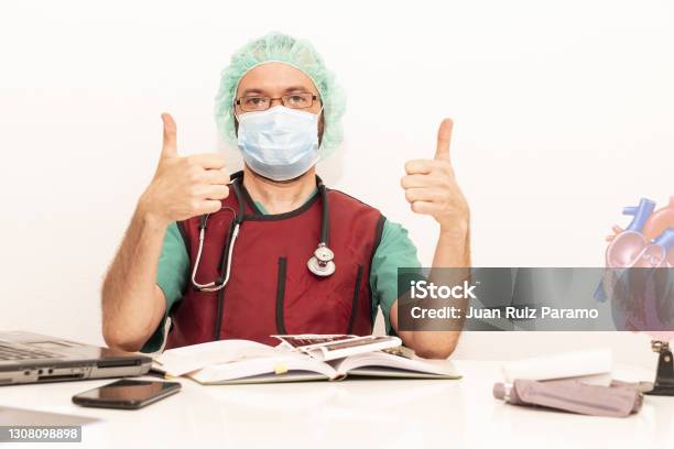 Cardiologist Doctor Working In His Office Wearing An Operating Theatre Suit And Lead Xray Protective Equipment White Background Stock Photo - Download Image Now