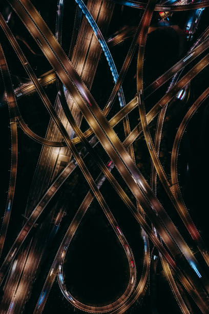 istock Aerial View of Complex Overpass and Busy Traffic at Night 1308099856