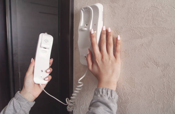 istock Caucasian young woman holding intercom receiver. 1308101951