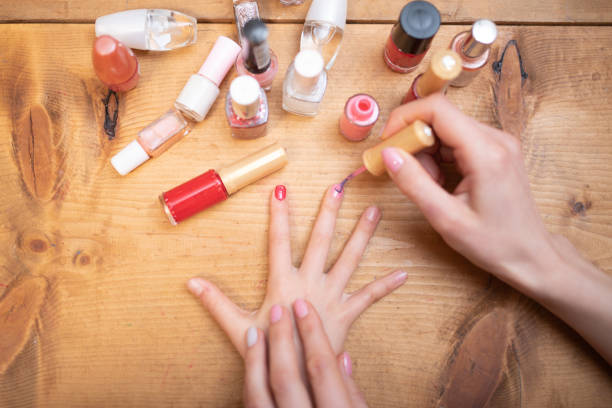 istock Mother's hand applying nail polish to her daughter's nails 1308102438