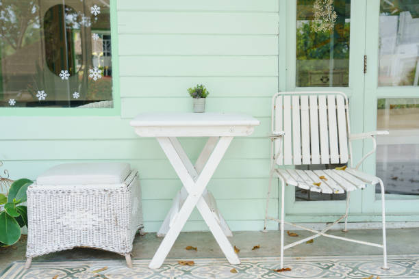 istock White chairs and table withe pastel green wooden wall , vintage style. 1308102581