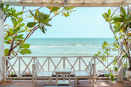 White chairs and table at balcony in sea view with beautiful blue sky. Relaxing and vacation.