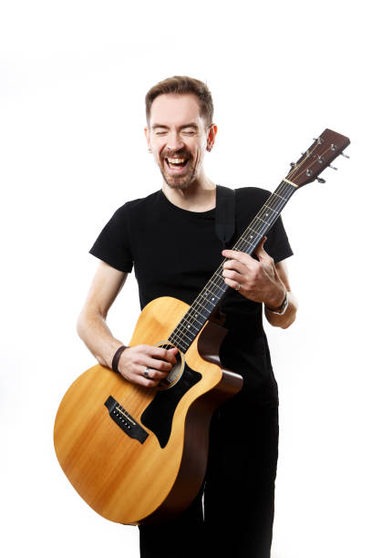 istock Guitarist playing and singing loudly on isolated a white background. 1308103662
