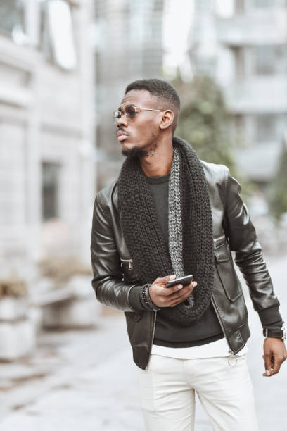 istock Modern Elegant African Male Using Smartphone While Walking In City Center 1308104448