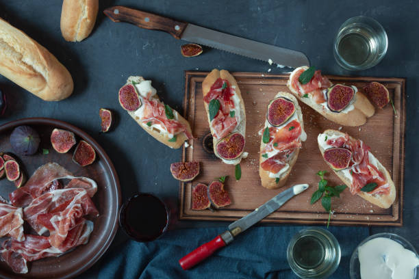 istock red and white wine and bruschetta with bacon on a dinner table. 1308105640