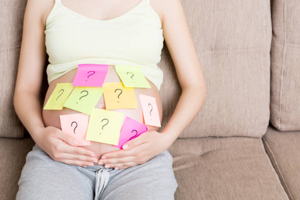 istock Pregnant woman belly with question mark. Pregnancy and thinking problem 1308105859