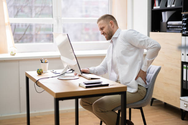 istock Bad Posture Sitting At Office Desk 1308110024
