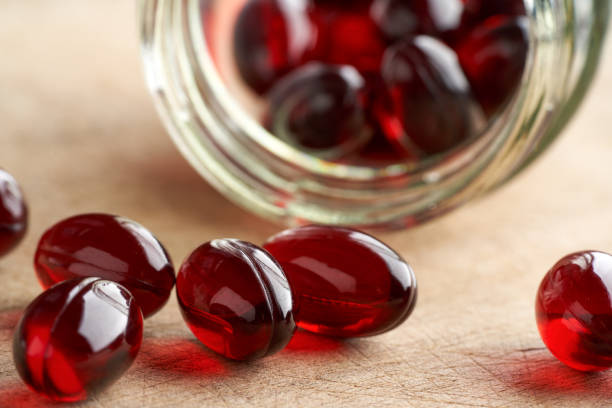 istock Krill oil capsules spilled from a glass bottle 1308110124