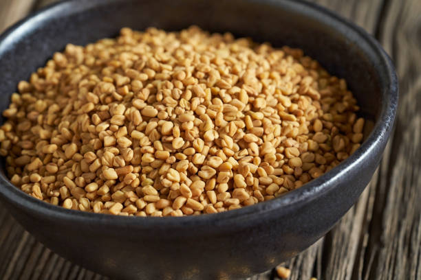istock Fenugreek seeds in a black bowl, closeup 1308110389