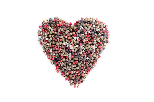 Mix peppercorns black, white, red and allspice in a wooden pestle with a chime for a mortar on a wooden background. dried spice peppercorn concept. Horizontal orientation. Selective focus. Copy space.