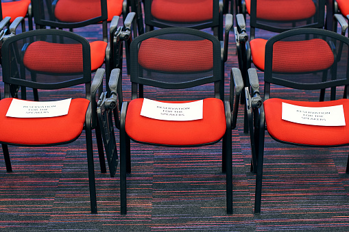 Red and black conference chairs in the empty auditorium