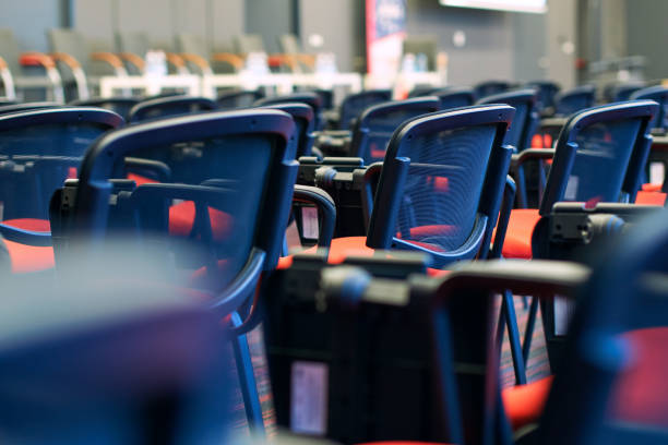 Red and black conference chairs in the auditorium Red and black conference chairs in the empty auditorium classroom empty education desk stock pictures, royalty-free photos & images