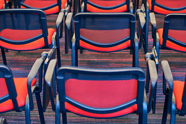 Red and black conference chairs in the empty auditorium