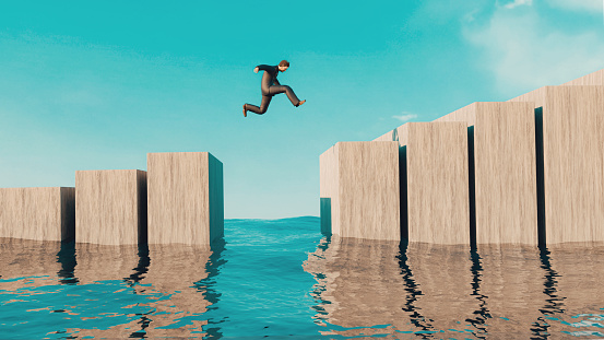 Digitally generated image of man jumping between blocks of concrete.