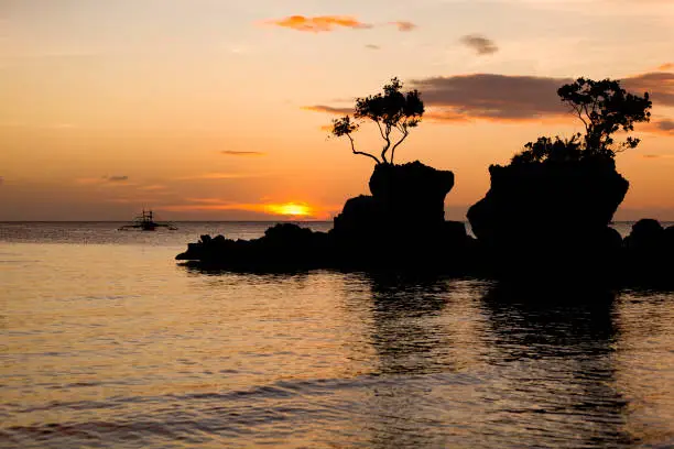 famous willy´s rock at sunset on boracay island in the philippines.