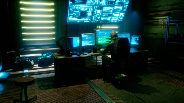istock A male hacker surrounded by glowing monitors hacks into someone else's computer network in a dark room of his office. 3D Rendering. 1308121404
