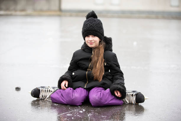 Little funny girl skating on ice in winter. Little funny girl skating on ice in winter. person falling backwards stock pictures, royalty-free photos & images