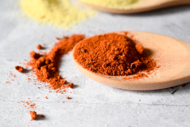 istock Parpika spice in wooden spoon on a gray table 1308124273