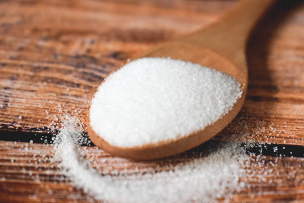 istock Spoon with salt on a wooden table 1308125047