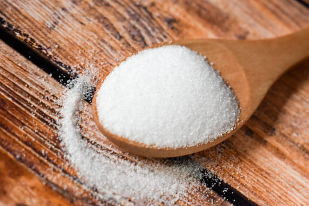 istock Spoon with salt on a wooden table 1308125130