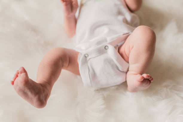 istock Newborn Baby Feet & Legs with a White Background 1308128351