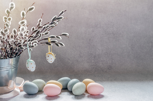 Easter minimal background with willow catkin branches in a decorative bucket.