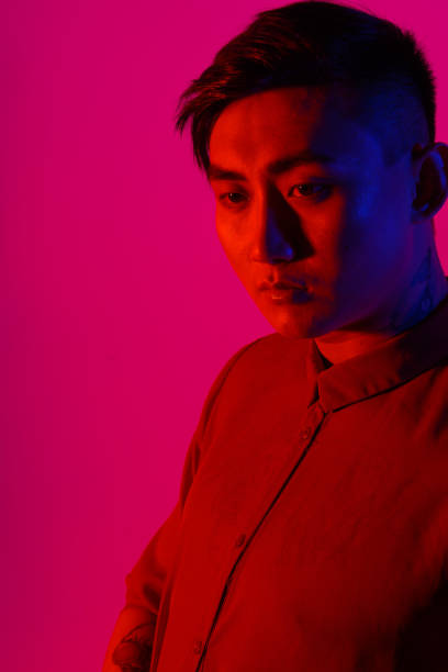 istock Fashionable Korean man in Studio on colored background 1308136256