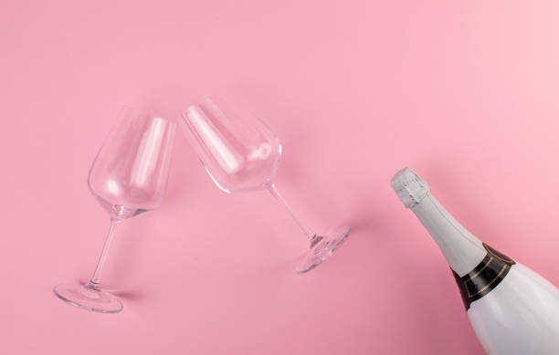 istock Two wine glasses on pink background 1308136383