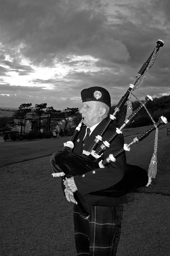 Trump Turnberry Ayrshire, Scotland, United Kingdom - October 1, 2004: Each evening a bagpiper in uniform plays the pipes as the sun sets on Trump Turnberry Resort in Scotland.