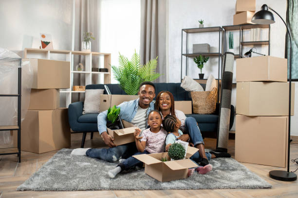istock African parents and kids sitting on floor among boxes 1308140018