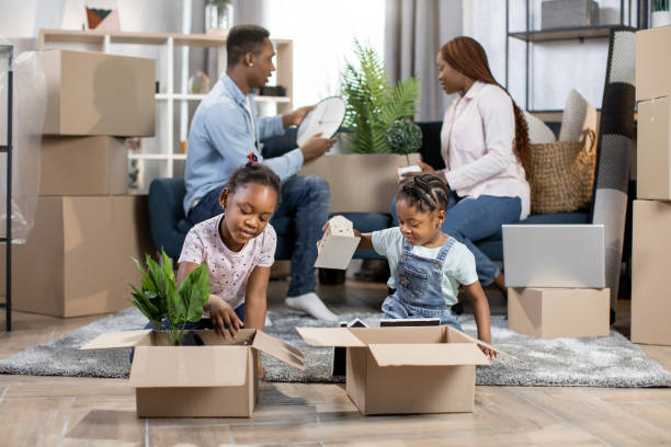 istock Kids playing while parents unpacking boxes at new flat 1308141145