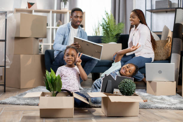 istock Parents unpacking boxes while kids playing at new flat 1308141271