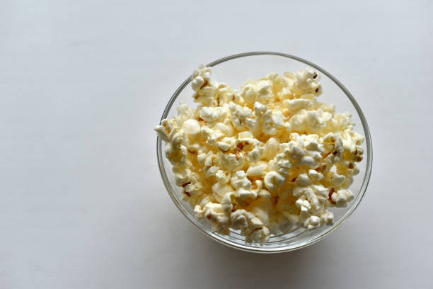 istock Glass saucer with popcorn on a white background 1308142050