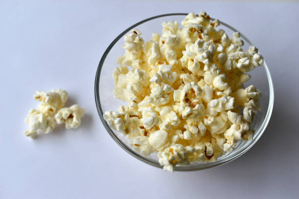 istock Glass saucer with popcorn on a white background 1308142054