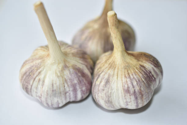 istock Three heads of garlic on a white background 1308142067