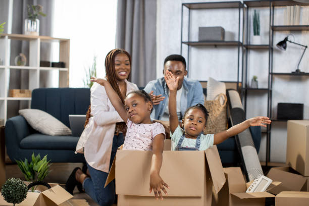 istock African kids playing in box while parents relaxing on couch 1308144289