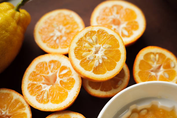Homemade Seville bitter orange marmalade series - juicing Preparation for making a small batch of homemade bitter orange marmalade in a domestic kitchen. Ingredients: Seville oranges (using the whole fruit, including peel and pips), Amalfi lemon juice and pips, preserving sugar, and water. amalfi food stock pictures, royalty-free photos & images
