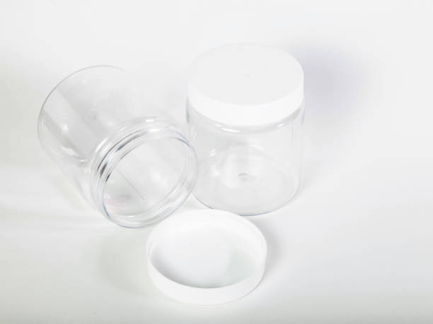 istock Cans for storing bulk products with white lids on light isolated background 1308146778